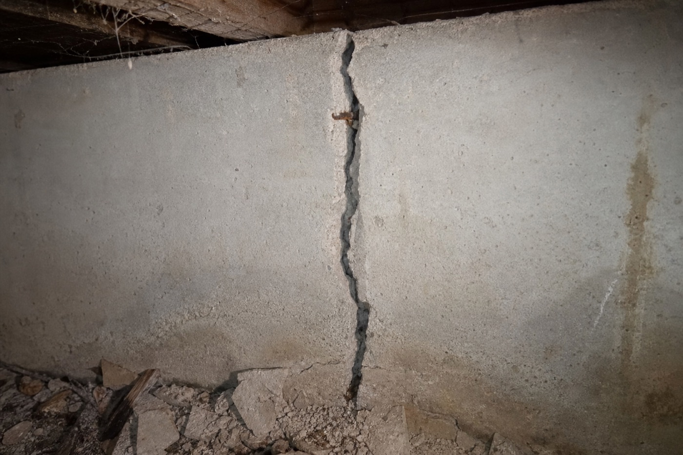 Vertical crack in a residential foundation wall indicating structural settlement